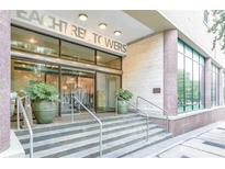 Building entrance featuring large windows and glass doors and stone stairs at 300 Peachtree St # Apt 9D, Atlanta, GA 30308