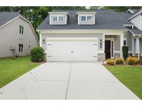 Charming home featuring a two-car garage with a concrete driveway and well-maintained landscaping at 4554 Grenadine Cir, Acworth, GA 30101