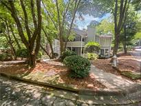 Two-story condo with balcony surrounded by mature trees and landscaping at 501 Vicksburg Pl, Atlanta, GA 30350