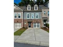 Charming townhouse featuring a brick and siding facade, private garage, and well-maintained front lawn at 1452 Ridgebend Se Way, Mableton, GA 30126