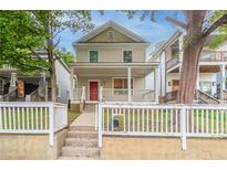 Charming two-story home featuring a welcoming front porch and a vibrant red front door at 639 Ira Sw St, Atlanta, GA 30312