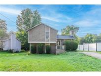 Charming two-story home featuring mature trees, inviting front porch, and a lush green lawn at 8670 Brandon Hill Ln, Jonesboro, GA 30238