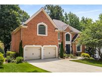 Beautiful brick home featuring a two-car garage and well-maintained landscaping, offering classic elegance at 290 Edwardton Ct, Roswell, GA 30076