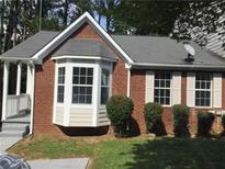 Charming brick home features a bay window, grey roof, and a cozy front porch at 3186 Kingswood Gln, Decatur, GA 30034