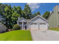 Charming two-story home featuring a two-car garage, well-maintained lawn, and a classic facade at 4968 Windsor Downs Ln, Decatur, GA 30035