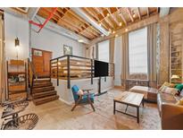 A naturally lit living room with a rustic wooden ceiling and a unique raised bedroom area at 650 Glen Iris Ne Dr # 26, Atlanta, GA 30308