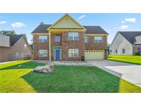 Charming two-story brick home with a lush green lawn and a welcoming blue front door at 85 Shiver Blvd, Covington, GA 30016