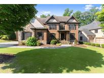 Charming two-story brick home with a well-manicured lawn and stone accents at 2539 Sagebrush Trl, Buford, GA 30519