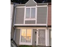 Traditional multi-level townhouse featuring wood siding and white trim around windows and doors at 404 Prince Of Wales, Stone Mountain, GA 30083