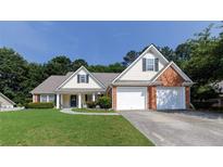 Charming home with a well-manicured lawn, brick accents, and a two-car garage, perfect for suburban living at 964 Natural Brook Trl, Lawrenceville, GA 30045