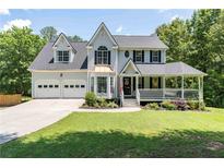 Charming two-story home with a well-manicured lawn, covered porch, and a two-car garage at 20 Scarlett Oak Ne Dr, Cartersville, GA 30121