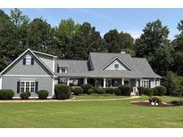 Charming one-story home with gray siding, a lovely front porch, and beautifully landscaped front yard at 200 Chaparral Trce, Tyrone, GA 30290