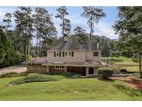 Charming two-story home with stone accents, mature trees, and manicured lawn at 1530 Niskey Lake Sw Trl, Atlanta, GA 30331