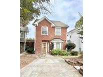 Charming two-story brick home with a well-manicured front yard and a cozy, inviting entrance at 3948 Oak Glenn Dr, Duluth, GA 30096