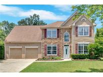 Attractive two-story home with stone accents, a well-kept lawn, and a two-car garage at 1002 Hallman Sw Ter, Marietta, GA 30064