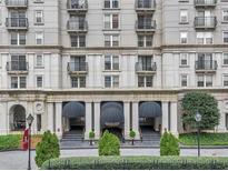 Beautiful exterior view of Mayfair Towers condos with a manicured lawn and covered entrance at 199 14Th Ne St # 1512, Atlanta, GA 30309