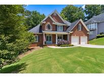 Charming brick home with a well-manicured lawn and inviting curb appeal at 2713 Misty Rock Cv, Dacula, GA 30019
