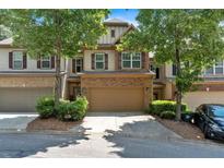 Charming townhome showcasing a two-car garage, stone accents, and well-maintained landscaping at 4349 Kousa Rd # 4, Austell, GA 30106
