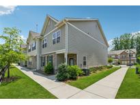 Charming townhouse with well-maintained lawn and sidewalk in a residential neighborhood at 6761 Cedar Glen Rd, Peachtree Corners, GA 30360