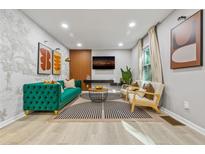 Modern living room with stylish decor, a plush green sofa, and eye-catching abstract artwork at 3408 Phillips Cir, Decatur, GA 30032