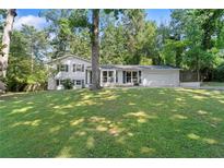 Charming home featuring a well-manicured front yard and a classic exterior with black shutters at 431 Hickory Se Ln, Smyrna, GA 30082
