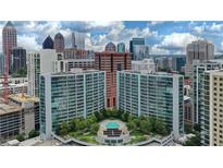 An aerial view of a condo building with a pool deck and cityscape in the background at 950 W Peachtree Nw St # 812, Atlanta, GA 30309