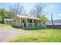 Charming exterior of a house with a cozy porch and a well-maintained front yard at 1422 Cassville Nw Rd, Cartersville, GA 30121