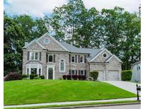 Beautiful two-story home with a well-manicured lawn, lush landscaping, and a two-car garage in a desirable neighborhood at 2115 Bentbrooke Trl, Lawrenceville, GA 30043