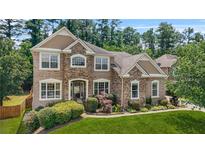 Beautiful brick home with manicured lawn and mature landscaping, offering great curb appeal at 2241 Chaseford Ln, Powder Springs, GA 30127