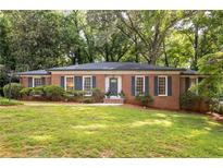 Charming brick home with manicured lawn and mature trees offering great curb appeal at 1342 Old Johnson Ferry Ne Rd, Brookhaven, GA 30319