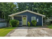 Charming, renovated home with a vibrant yellow door and well-maintained front yard at 1696 Thomas St, Decatur, GA 30032