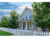 Charming two-story home features a well-manicured lawn and a welcoming white picket fence at 3057 Windover Ln, Kennesaw, GA 30144