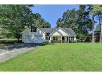 Charming one-story home boasts a two-car garage and a well-manicured front lawn at 969 Bob Hannah Cir, Lawrenceville, GA 30044
