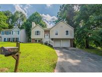Charming two-story home featuring an attached two-car garage and a well-maintained front yard at 1060 Heatherwood Ct, Norcross, GA 30093