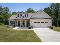 Charming single-Gathering home with a two-car garage and meticulously manicured front yard at 2124 Bullock Bluff Dr, Loganville, GA 30052