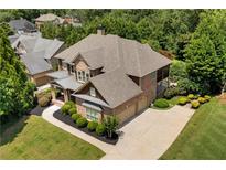 Beautiful brick home featuring a well-manicured lawn and an attached two car garage at 307 Heritage Overlook, Woodstock, GA 30188