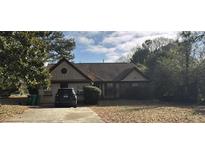 Charming single-story home featuring a cozy front yard and a well-maintained driveway at 3390 Autumn Cherry Ct, Decatur, GA 30034