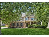 Charming two-story home with brick and siding, well-manicured lawn, and mature trees at 558 Grand Ivey Pl, Dacula, GA 30019