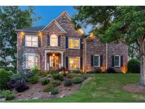 Beautiful two-story brick home with a manicured front yard and inviting curb appeal at 7048 Bennington Ln, Cumming, GA 30041