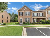 Charming townhome with neutral siding, black shutters, and well-maintained landscaping at 3028 Sw Deerborne Court Sw Ct, Atlanta, GA 30331
