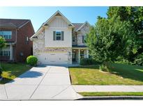 Charming two-story home with a well-manicured lawn and attached two-car garage at 2600 Arnold Palmer Way, Duluth, GA 30096