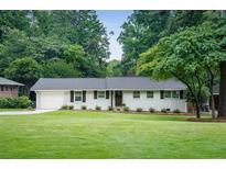 Charming single-story home with well-manicured lawn and mature trees at 2617 Warwick Ne Cir, Atlanta, GA 30345
