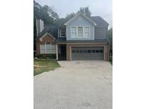 Charming two-story home featuring a two-car garage, brick accents, and a well-maintained front yard at 1910 Glynmoore Dr, Lawrenceville, GA 30043