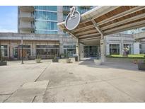 Modern building with covered entrance featuring '12 Midtown' signage and well maintained landscaping at 361 17Th St # 910, Atlanta, GA 30363