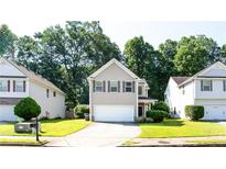 Charming two-story home featuring neutral siding, a well-manicured lawn and a two car garage at 4628 Mcever View Dr, Sugar Hill, GA 30518