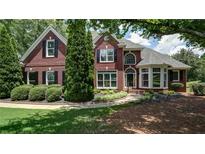 Charming brick two-story home with manicured landscaping and a welcoming front entrance at 127 Grandmar Chase, Canton, GA 30115