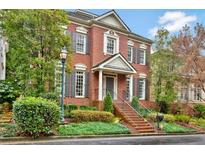 Charming brick home with lush landscaping, gray shutters, and a welcoming front entrance at 49 Conifer Park Ln, Atlanta, GA 30342
