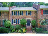 Charming brick townhome with blue shutters and professionally landscaped front yard at 1105 Clairemont Ave # J, Decatur, GA 30030