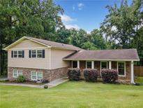 Charming home featuring a stone facade, light siding, and a well-manicured front lawn at 2941 Foothill Trl, Marietta, GA 30066