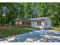 Charming single story home featuring a large yard and lovely covered front porch perfect for relaxing at 995 Highway 101 S, Temple, GA 30179
